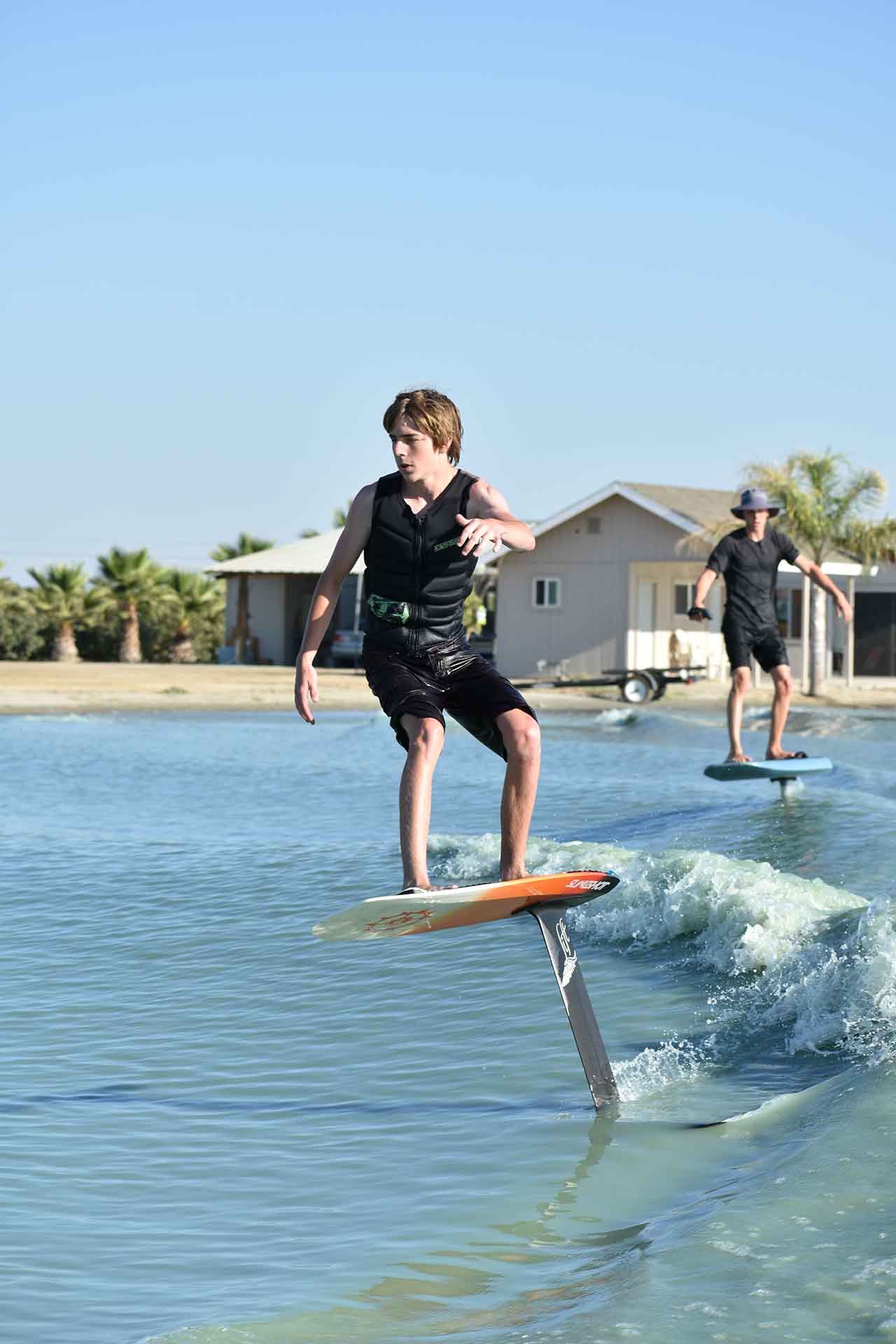 Wake foil surfing with an efoil in the background